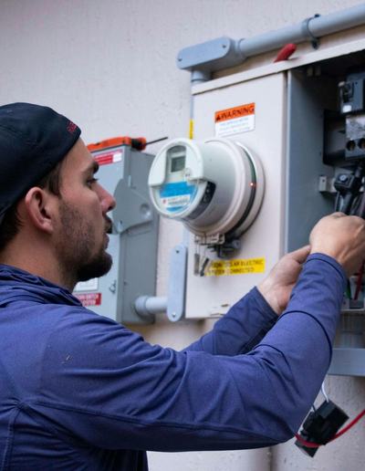 Electrician working at an outdoor meter panel